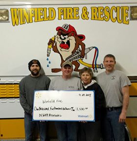 Winfield, Iowa Fire department was a recipient of the Walmart Foundation Community Grant.  Pictured are Matt Nelson, Josh Sparrow, DC 6009 associate Patti Gerling and Chad Venghaus.